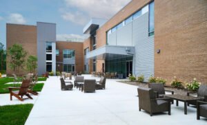 Exterior architectural photograph of the Emergency Response Training Facility courtyard patio with modern outdoor lounge furniture and brick facade by Dwayne Hickson, Graphic Productions in Oak Ridge, TN.