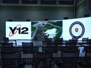 Commercial interior photograph focusing on a vibrant curved LED screen showing Y-12 ORETTC insignia in an emergency training classroom by Dwayne Hickson, Graphic Productions in Oak Ridge, TN.