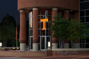 Architectural dusk exterior photograph of Brenda Lawson Athletic Center rotunda and Regal Entertainment Group Plaza with illuminated Power T by Dwayne Hickson, Graphic Productions in Knoxville, TN.