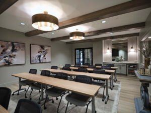 Commercial interior photograph of training room with hospitality station, mini beverage fridge, and light wood seminar desks by Dwayne Hickson, Graphic Productions in Knoxville, TN.